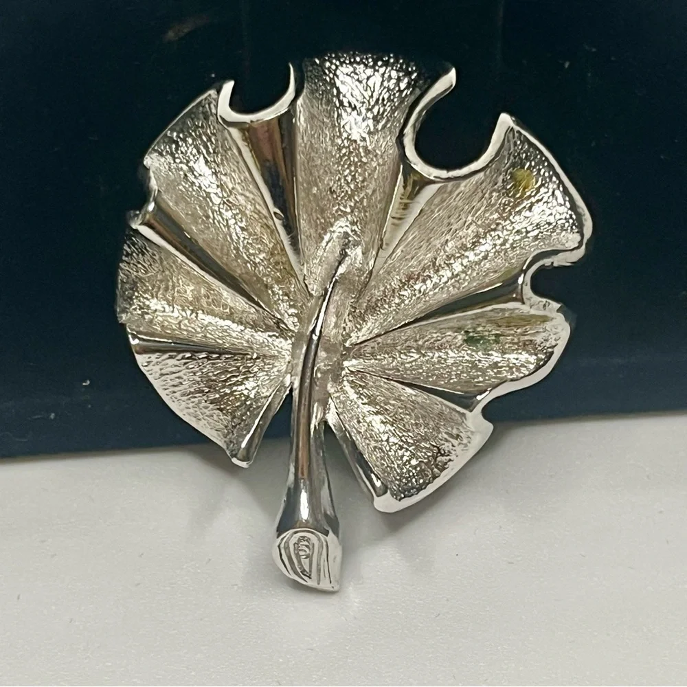 Two Elegant Silver tone Sarah Coventry brooches.